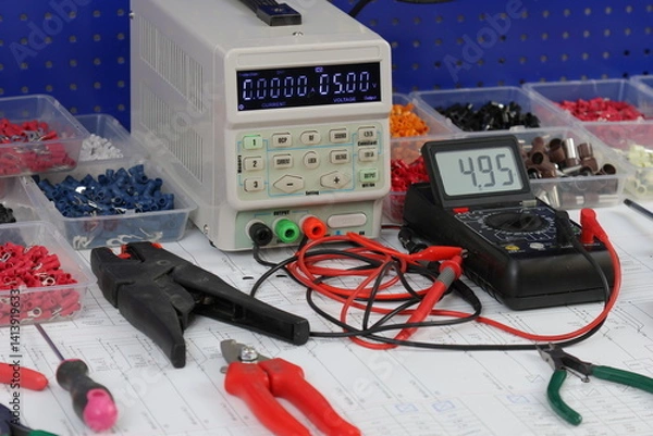 Fototapeta Multimeter for measuring the parameters of electrical circuits and mounting tools for assembling an electrical panel. On the electrical diagram. 