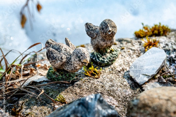 Obraz Statue of baby birds in the middle of a thawed patch of snow. Old sparrows sculpture. Kegums Cross Hill, Latvia.