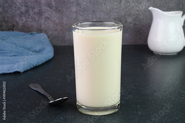 Obraz Serving vanilla milkshake in a glass cup.