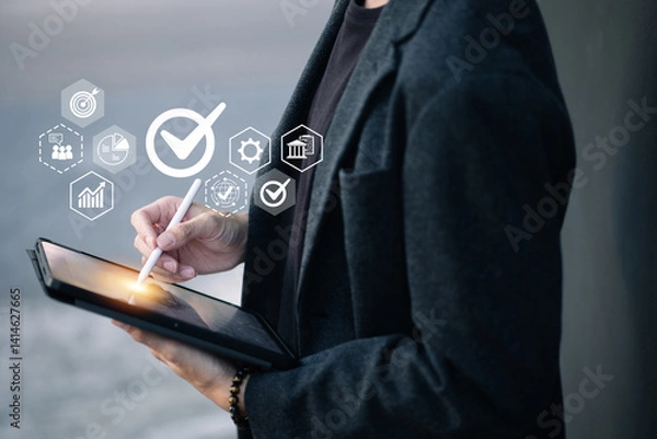 Obraz A person holds a tablet while using a stylus, with floating icons around them including a checkmark, chart, gear, and globe—symbolizing digital approval, analysis, and global access.