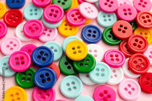 Obraz Colorful buttons scattered on a pink surface. Close up little buttons.