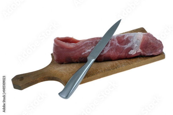 Fototapeta Filet mignon cru sur une planche à découper avec un couteau en gros plan isolé sur fond blanc
