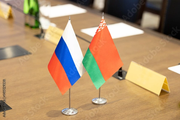 Fototapeta Flags of cooperation between Russia and Belarus. Flags of Russia and Belarus on the negotiating table. Ideal for news.