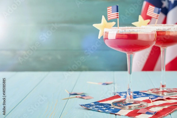 Fototapeta 4th of July Holiday background. Cranberry punch with ice and stars shaped apple pieces in glass against background of old turquoise board and sun rays. Patriotic American Flag drinks. Design element.
