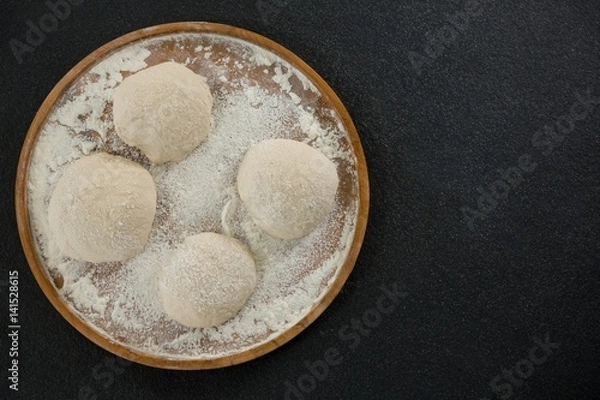 Fototapeta Bread dough ball on a wooden tray