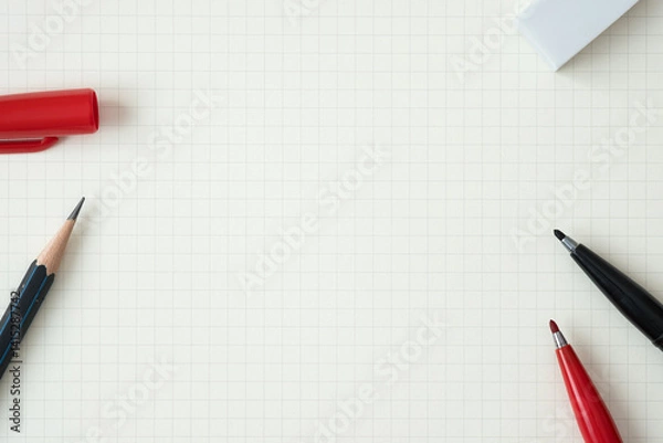 Fototapeta Top view, Close-up of Red and Black Felt-tip Pen, Pencil and Eraser on Graph Paper Background, Copy Space for Text, Flat Lay Concept.