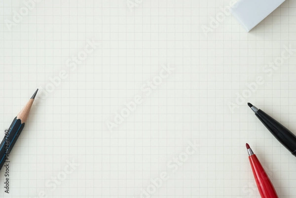 Fototapeta Top view, Close-up of Red and Black Felt-tip Pen, Pencil and Eraser on Graph Paper Background, Copy Space for Text, Flat Lay Concept.