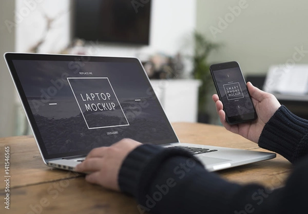Fototapeta User with Smartphone and Laptop on Desk Mockup 3