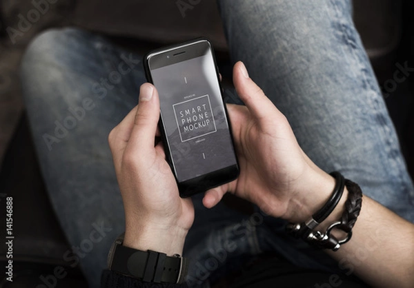 Fototapeta Top View Mockup of a Smartphone in User's Hands 1