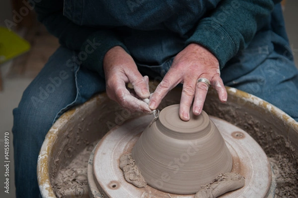 Fototapeta womans hands creating pottery objects in a ceramics workshop
