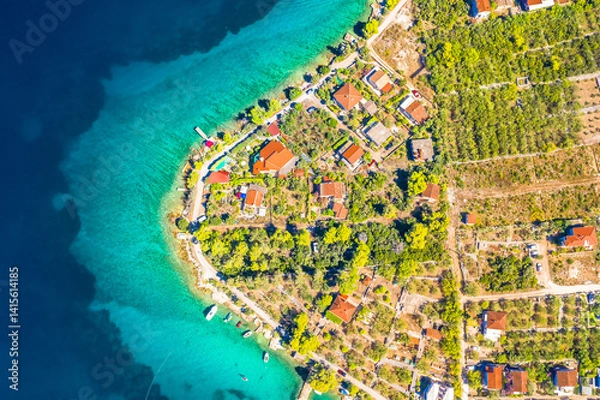 Fototapeta Top down aerial view of the stunning coastline in Necujam on Solta Island, Croatia, showing vivid turquoise waters, and Mediterranean vegetation along the peaceful Adriatic coast