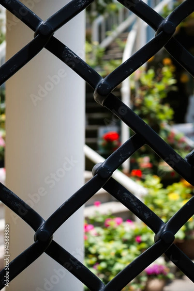 Fototapeta close-up of a black metal fence with blurred background