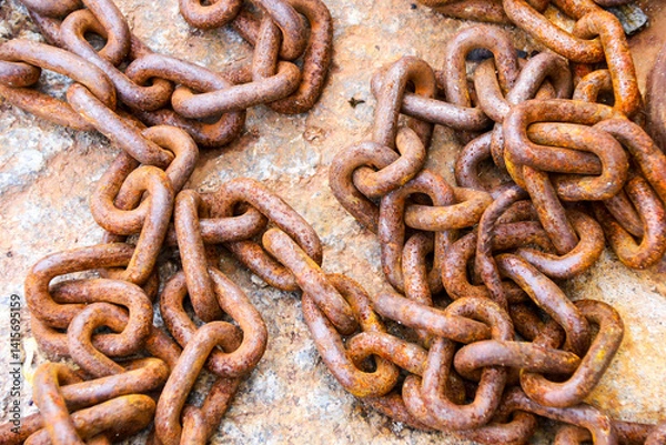 Fototapeta Rusty chains on stone floor on the dock