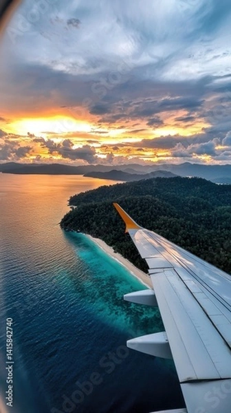 Fototapeta A plane is flying over a beautiful ocean with a sunset in the background