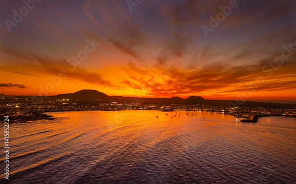 Obraz Spectacular aerial panoramic landscape image of the evening sunset sky at golden hour over the town of Corralejo, Fuerteventura, Canary Islands, Spain