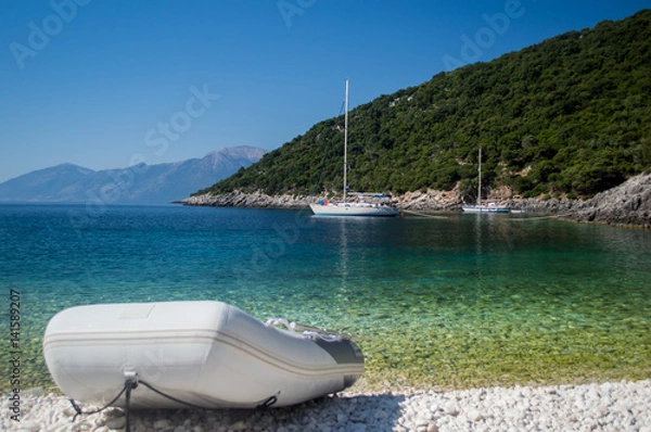Fototapeta Dinghy at a remote beach