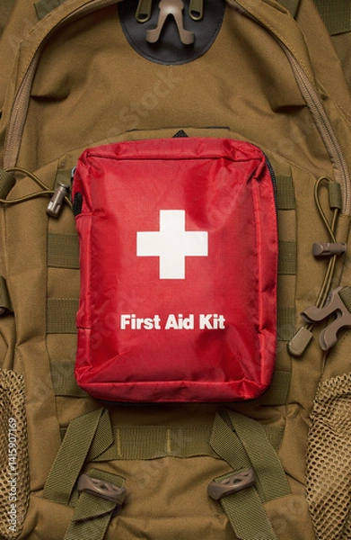 Fototapeta First Aid Kit on army backpack