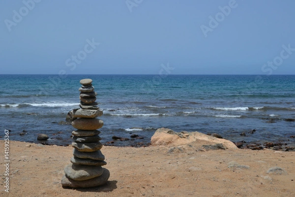 Obraz Pebble tower - balance harmony. Stones arranged in a pyramid on the coast of the sea beach. Balance and philosophy of spiritual peace. Therapy, spa, summer travel vacations