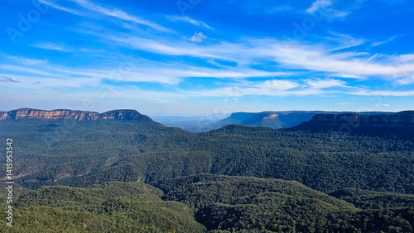 Fototapeta Blue Mountains of New South Wales, Australia.Vast mountain landscape under a blue sky with wispy clouds in a serene afternoon setting
