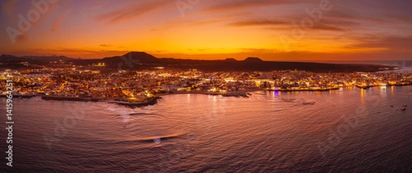 Obraz Spectacular aerial panoramic landscape image of the evening sunset sky at golden hour over the town of Corralejo, Fuerteventura, Canary Islands, Spain