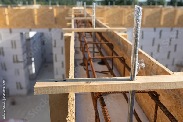 Obraz Close-up of Construction Site: Detailed View of Rebar and Wooden Formwork for Concrete Foundation