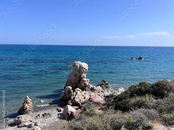 Obraz Aphrodite Beach with Stone Rocks in Aphrodite bay of Mediterranean sea water, blue sky in sunny day background, Petra tu Romiou, Cyprus