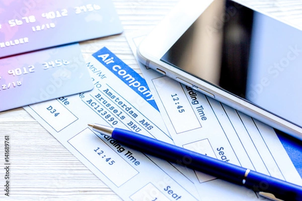 Fototapeta Credit cards with airline tickets for vacations on table background