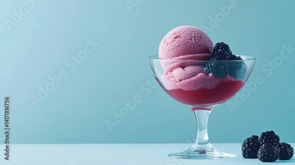 Obraz A delicious blackberry sorbet scoop in a glass bowl, with fresh blackberries and a drizzle of honey, set on a clean, modern background with copy space.