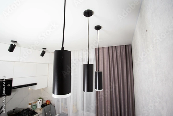 Fototapeta Modern black diode pendant lamps on a white stretch ceiling, designer, close-up