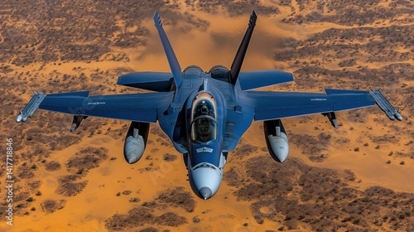 Obraz A powerful military aircraft glides effortlessly above vast sandy terrain under the sun