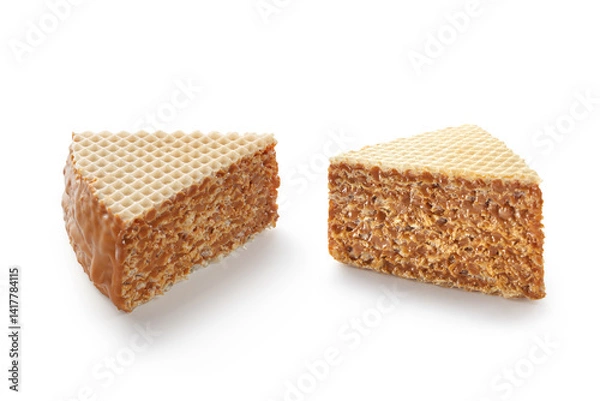 Fototapeta Two slices of waffle cake with caramel or condensed milk isolated on white