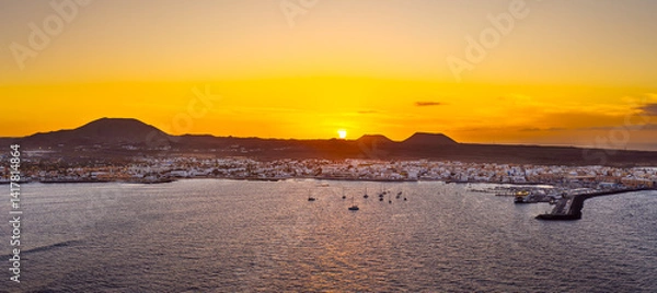 Obraz Spectacular aerial panoramic landscape image of the evening sunset sky at golden hour over the town of Corralejo, Fuerteventura, Canary Islands, Spain
