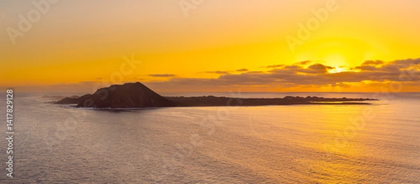 Obraz Spectacular golden hour sun rise image of the view over the volcanic island Isla de Lobos, near Corralejo, Fuerteventura, Canary Islands Spain