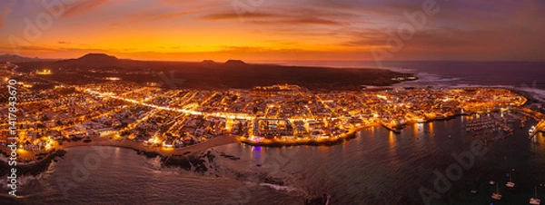 Obraz Spectacular aerial panoramic landscape image of the evening sunset sky at golden hour over the town of Corralejo, Fuerteventura, Canary Islands, Spain