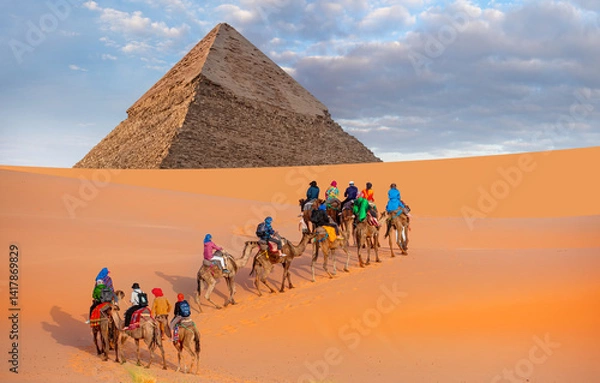 Obraz A Group of tourist riding a camel - Camels in Giza Pyramid Complex - Cairo, Egypt