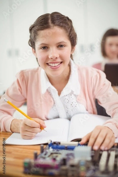 Obraz Schoolgirl working on electronic project in classroom