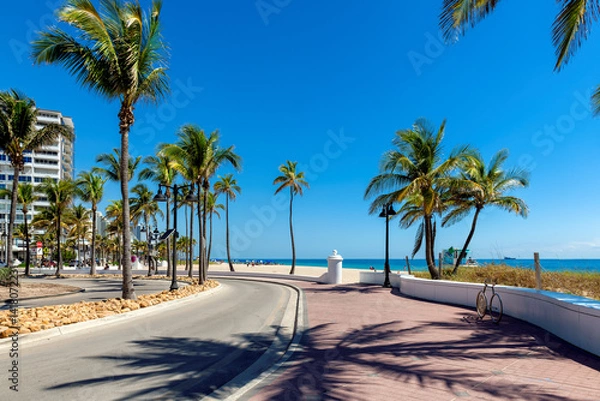Fototapeta Seafront promenade and wonderful beach with palm trees on a sunny summer day in Fort Lauderdale beach, Florida