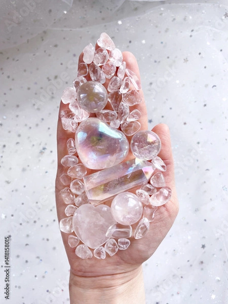 Fototapeta Hand of a human medium, healer, magician holds a crystal heart and other crystals of various shapes in the palm of his hand