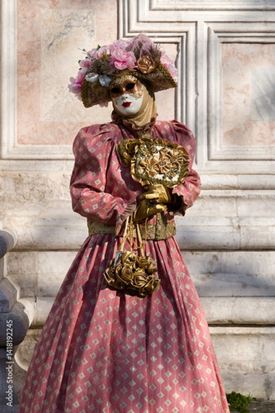 Obraz Venice, Italy - People dressed in carnival masks are photographed by tourists in the scenery of the ancient Venetian palaces