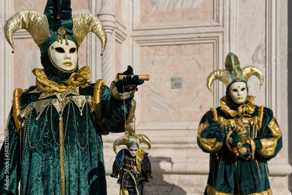 Obraz Venice, Italy - People dressed in carnival masks are photographed by tourists in the scenery of the ancient Venetian palaces