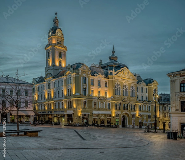Fototapeta Town Hall in Pécs with the yellow facade in twilight hour