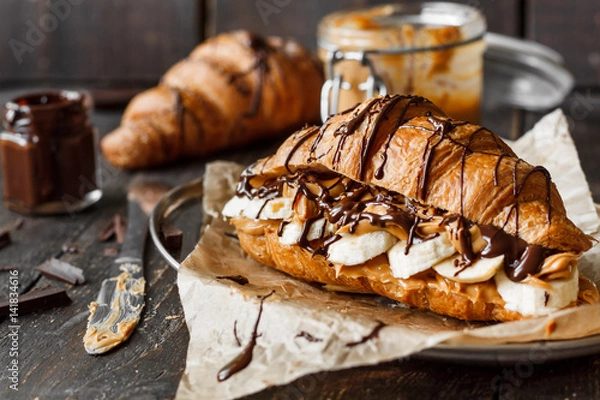 Fototapeta Croissant with banana, peanut butter and chocolate