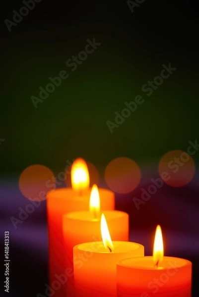 Obraz Warm, glowing candles against a dark background.