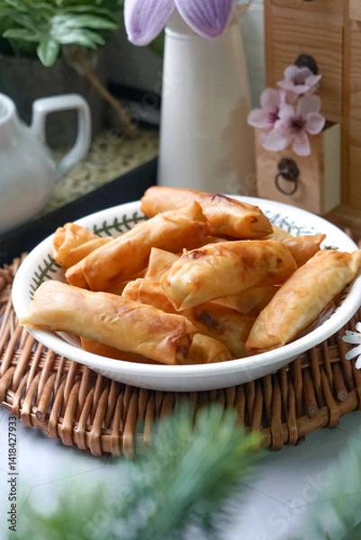Fototapeta Fried spring rolls or Popiah Goreng, crispy fried spring roll filled with vegetables, meat or prawns, offering a crunchy delight.  Usually served for breakfast or afternoon tea.