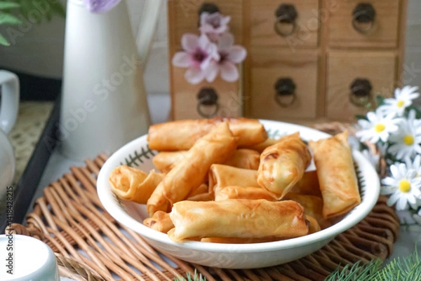 Fototapeta Fried spring rolls or Popiah Goreng, crispy fried spring roll filled with vegetables, meat or prawns, offering a crunchy delight.  Usually served for breakfast or afternoon tea.
