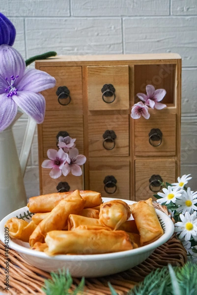 Fototapeta Fried spring rolls or Popiah Goreng, crispy fried spring roll filled with vegetables, meat or prawns, offering a crunchy delight.  Usually served for breakfast or afternoon tea.