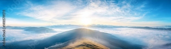 Fototapeta Panoramic view of Carpathian Mountains with foggy valley and sunlight on mountain peak under vibrant blue sky with clouds, wide high-resolution morning landscape background