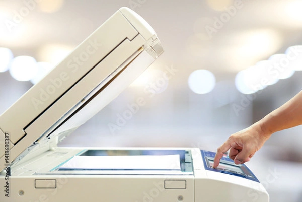 Fototapeta Businessman use photocopy or copier or photocopier in office workplace is equipment for copy duplicate Xerox or scanner to scanning document or printer for printing paper.