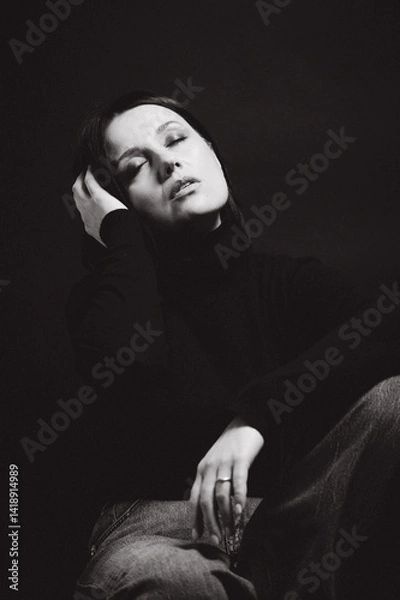 Obraz Portrait of a woman with dark hair, done in low key style.
