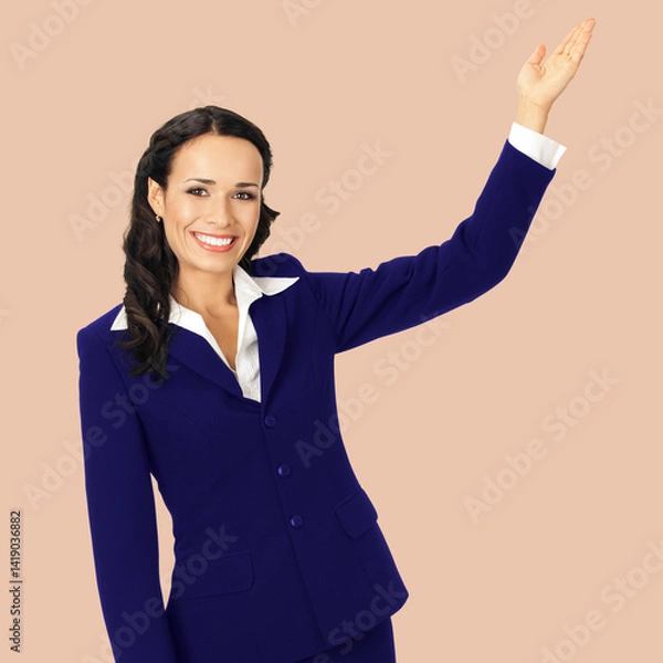 Fototapeta Portrait image - happy smile businesswoman show pointing advertise ad text space. Corporate business woman executive employee bank manager, teacher isolate pastel plain brown beige background. Square